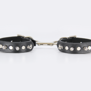 Front view of leather ankle cuffs with 3 short dog spikes with 4 silver rivets on each cuff.