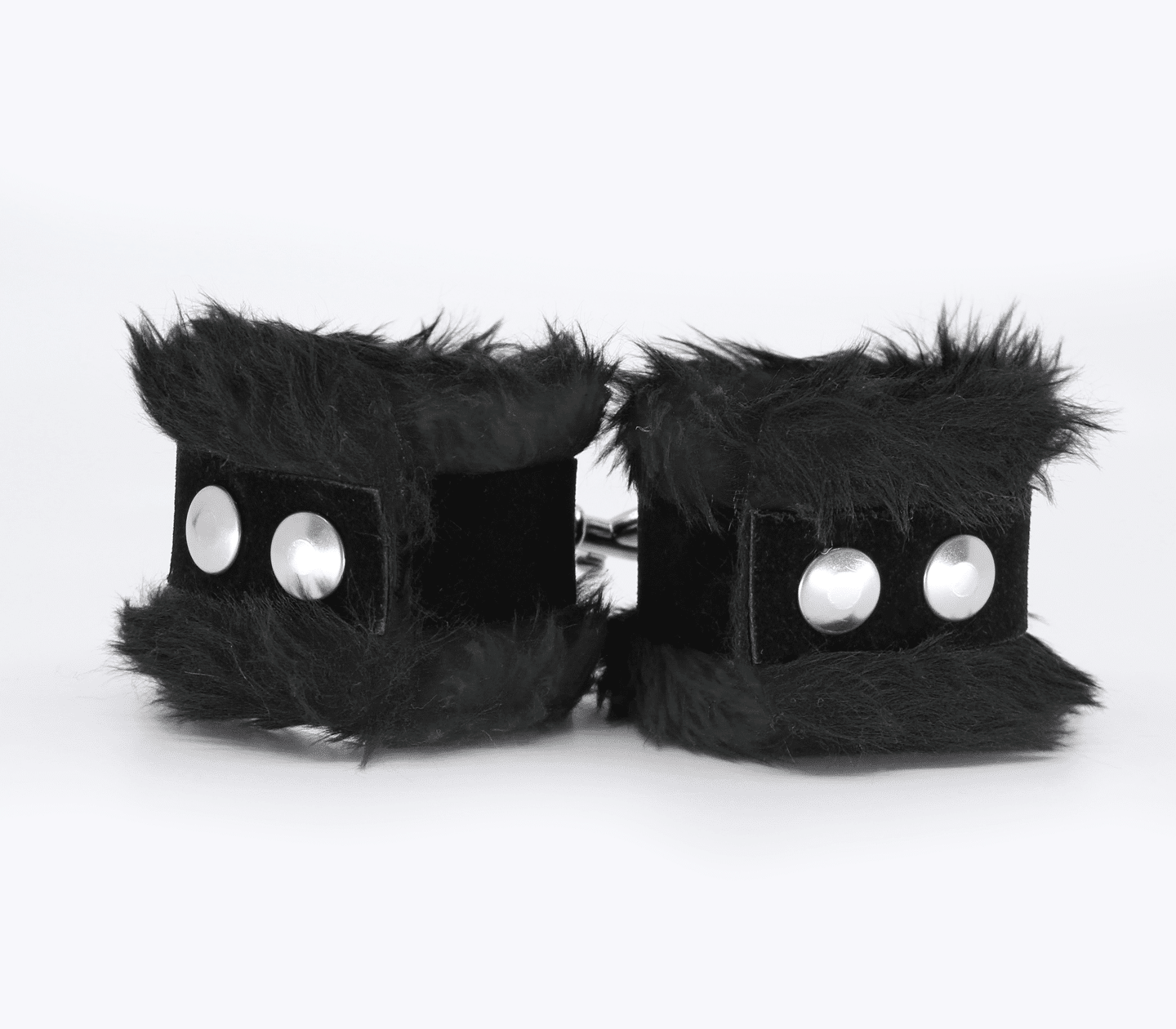 Back view of black fluffy wrist cuffs with black centre strap and silver snap buttons.