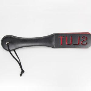 black pu paddle with red word cutout slut