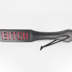 black pu paddle with red cut out word bitch